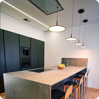 image of a contemporary kitchen with pendant light over kitchen island and led strip in the cove